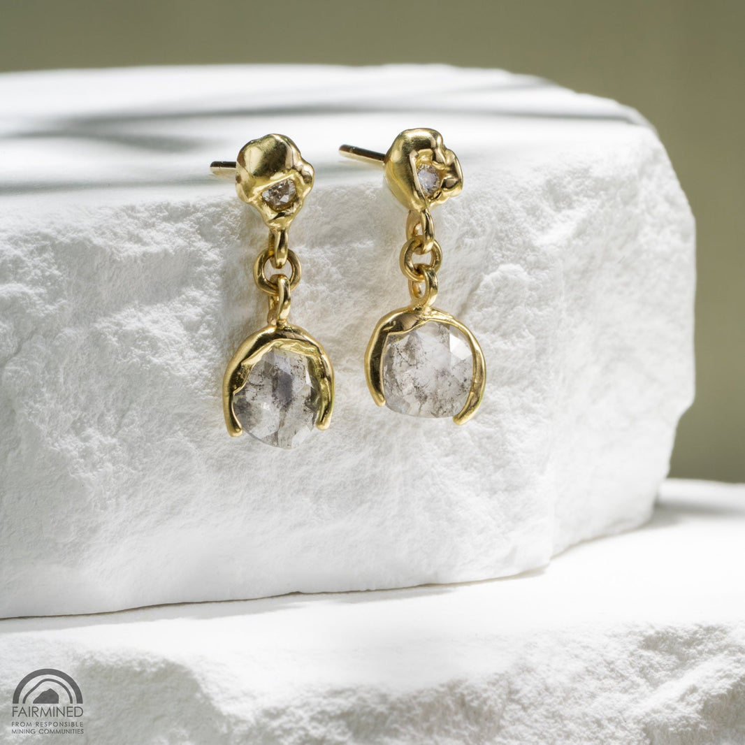 a pair of Malleable diamond and gold earrings