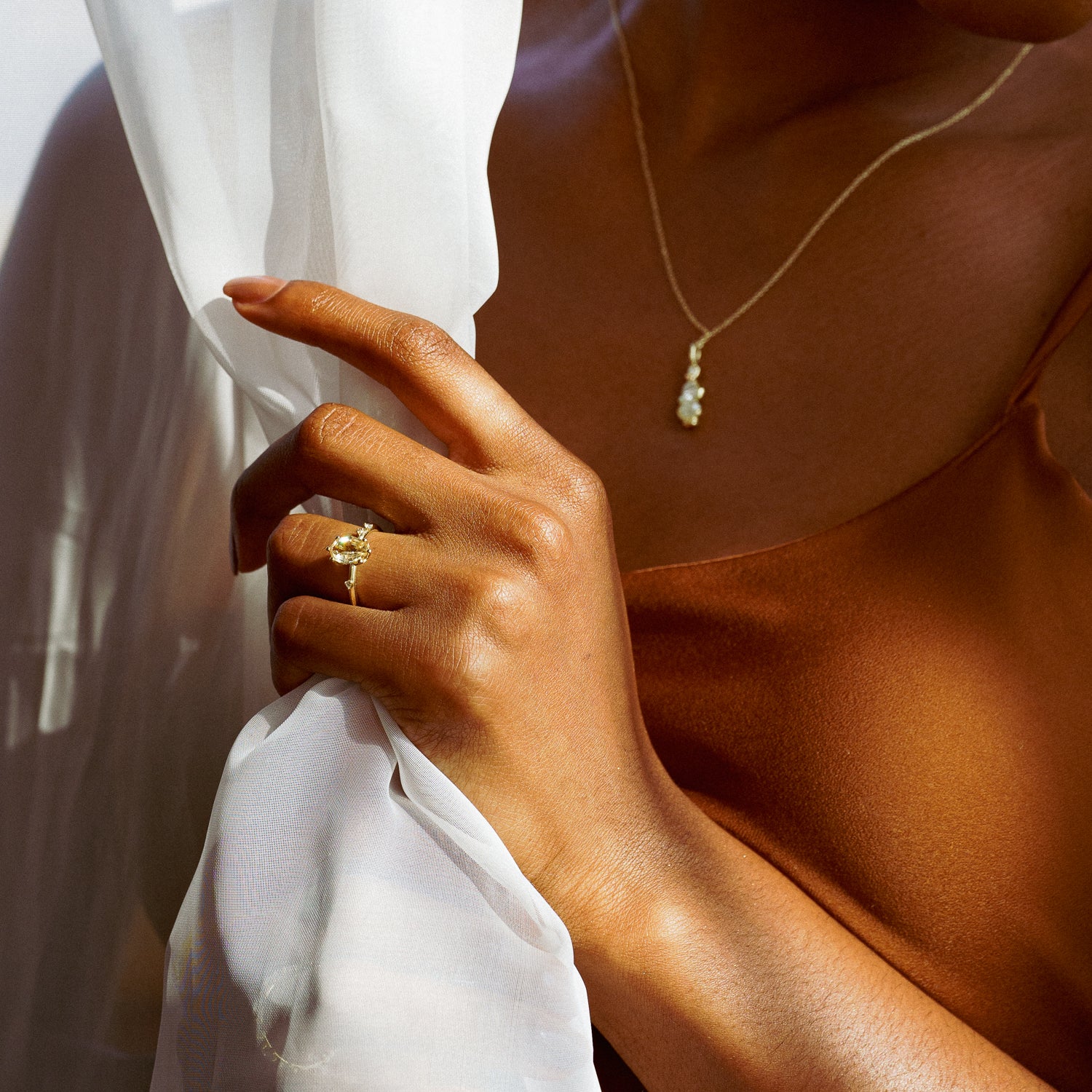 Sunrise Ring in Fairmined Yellow Gold with Portrait Cut Yellow Oval Natural Sapphire and Natural Recycled Colourless Diamonds with Leaf Motif Setting