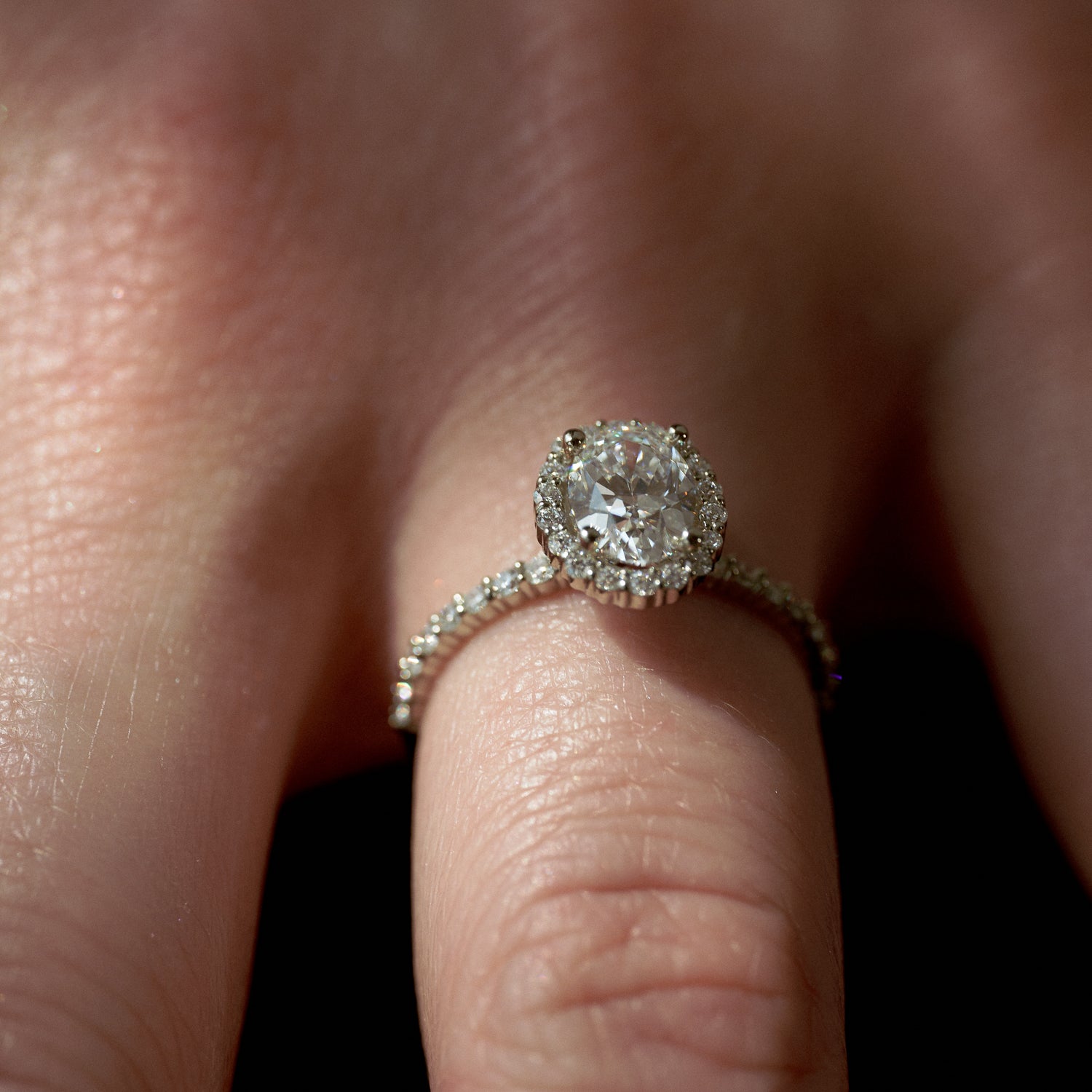 Timeless Halo in 18 karat Fairmined White Gold with colourless lab grown diamonds and Carbon Capture Aether centre oval diamond