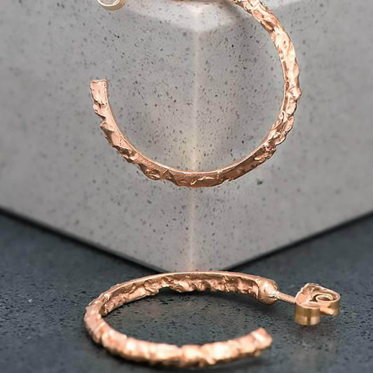 Irregular, baroque carved hoop earrings in satin finish 10 karat recycled rose gold.