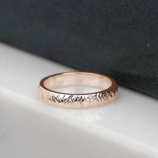 Cross hatch hammer textured and polished ring in recycled 14 karat rose gold.