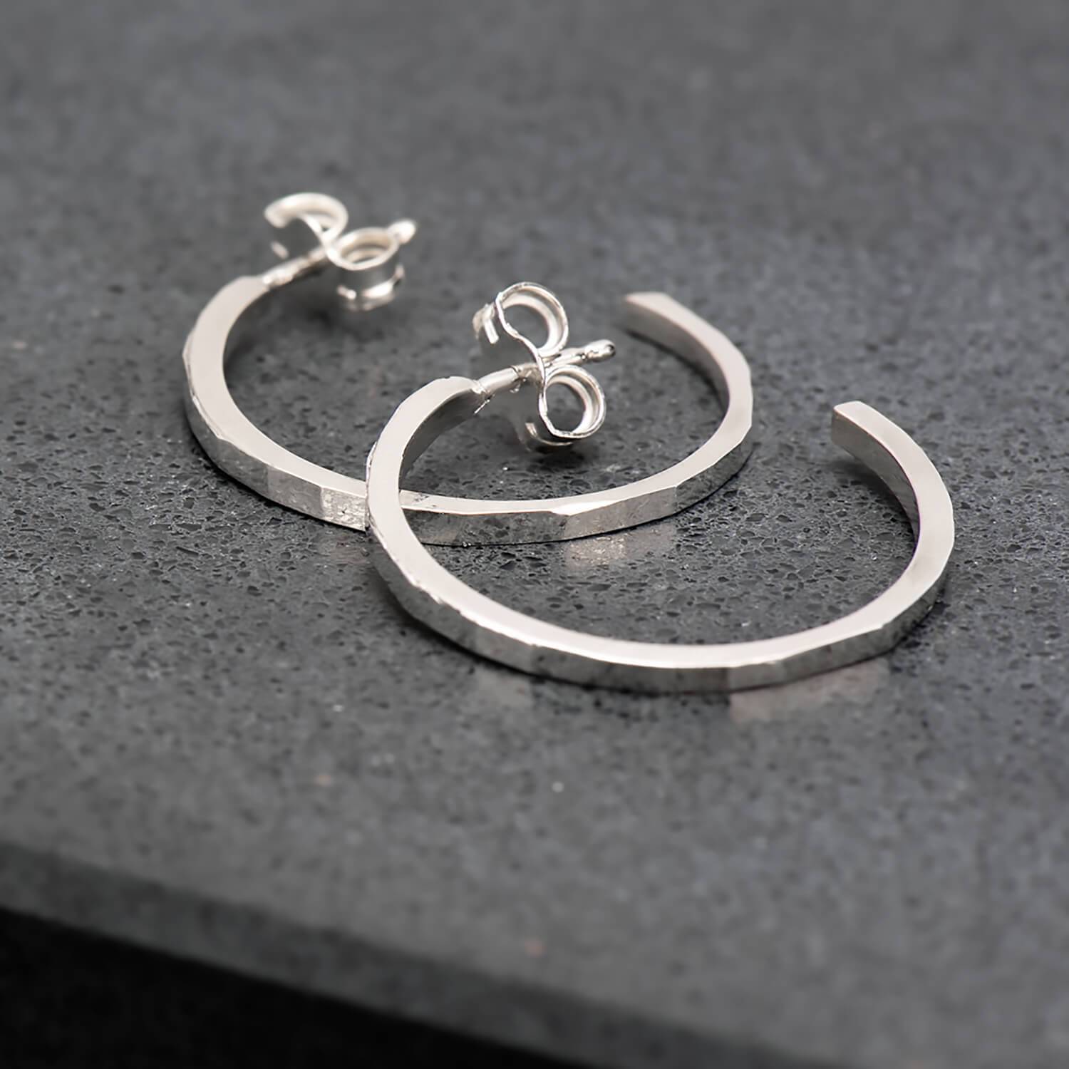 Thin, hammer finished hoop earrings in recycled sterling silver.