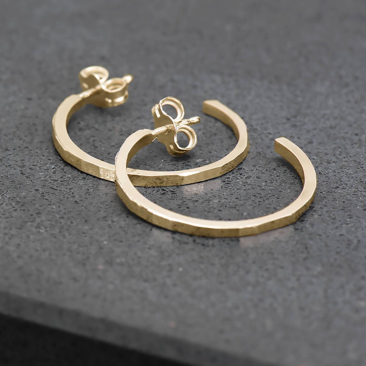 Thin, hammer finished hoop earrings in 10 karat recycled yellow gold.