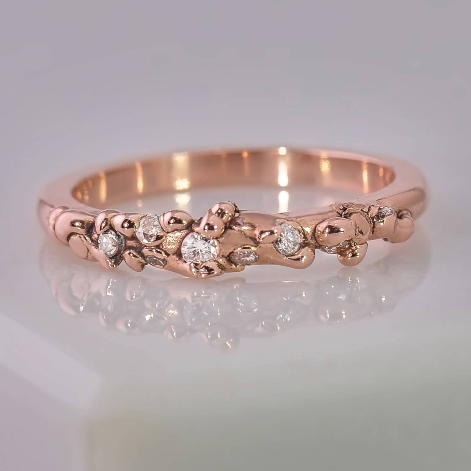14 karat recycled rose gold with 9 recycled natural colourless diamonds with a total weight of 0.14 carats. The surface has a globular structure and a high polished lustre