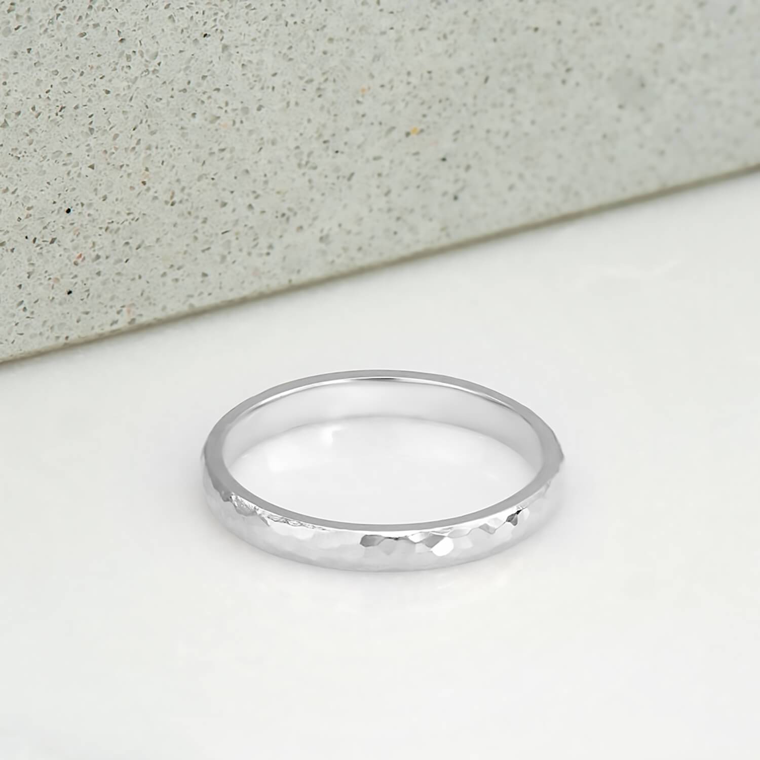 2 milimetre wide ring, polished and hammer finished, in 14 karat recycled white gold.
