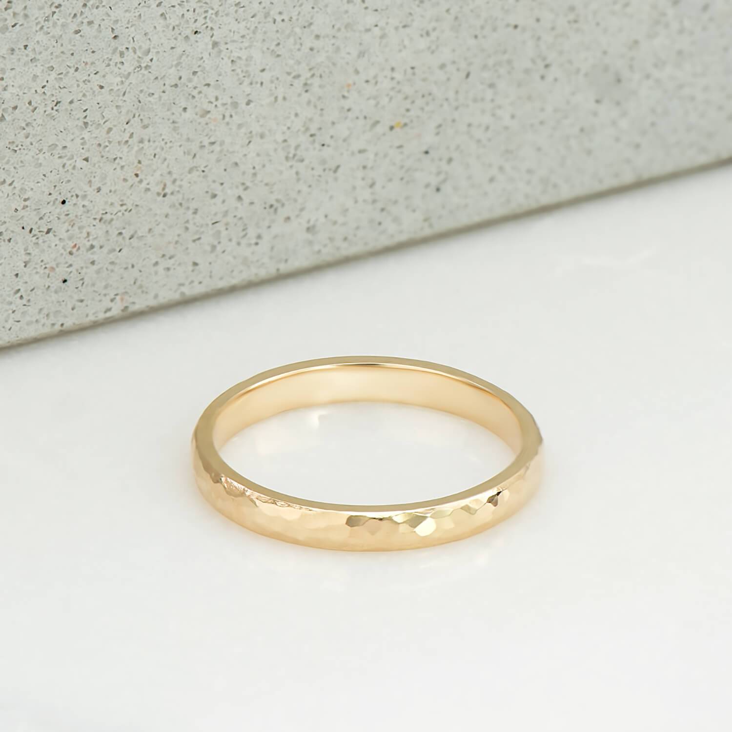 2 milimetre wide ring, polished and hammer finished, in 14 karat recycled yellow gold.