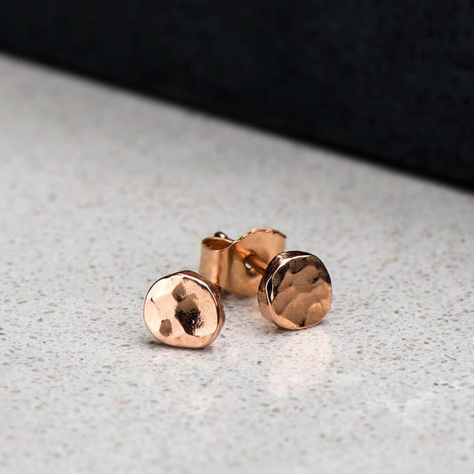 10 karat rose gold circular hammer finished studs brought to a high polish, approximately 4.2mm in diameter