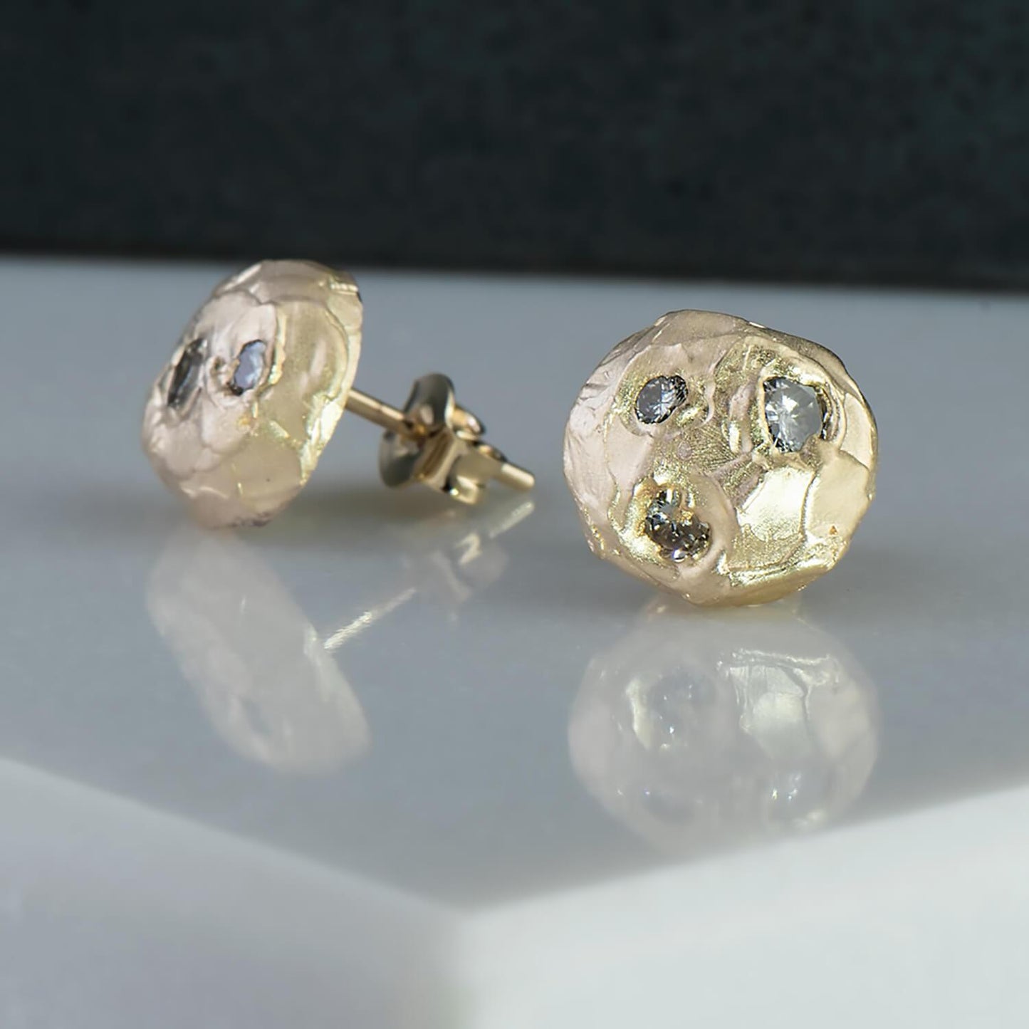 14 karat recycled yellow gold studs with 5 recycled natural colourless diamonds with a total wight of 0.52 carats. The profile is a half sphere whilst having a luscious texture helping light reflect off.