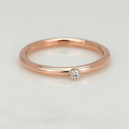 High polish 10 karat recycled rose gold band, with a 2 millimetre natural clear diamond in a six prong setting.