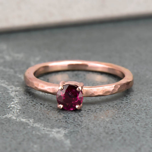 Recycled 14 karat rose gold hammer finished ring in which houses a 0.30 carat natural heat treated round ruby.