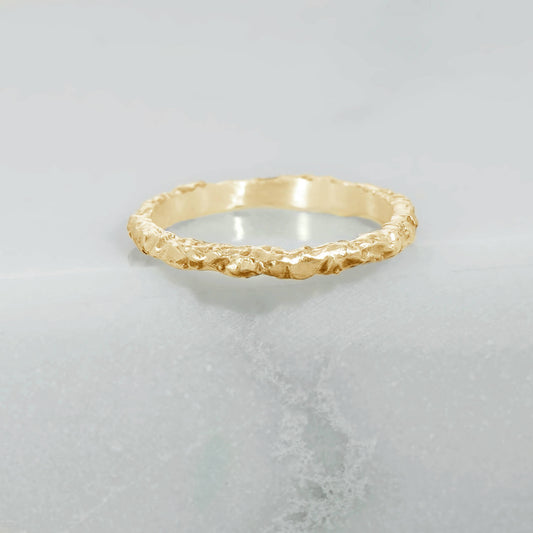 Baroque textured ring in recycled 10 karat yellow gold, thickness of 1.2mm and a width of 2mm. The exterior sheen of the band is satin finished and the inside of the band is high polished