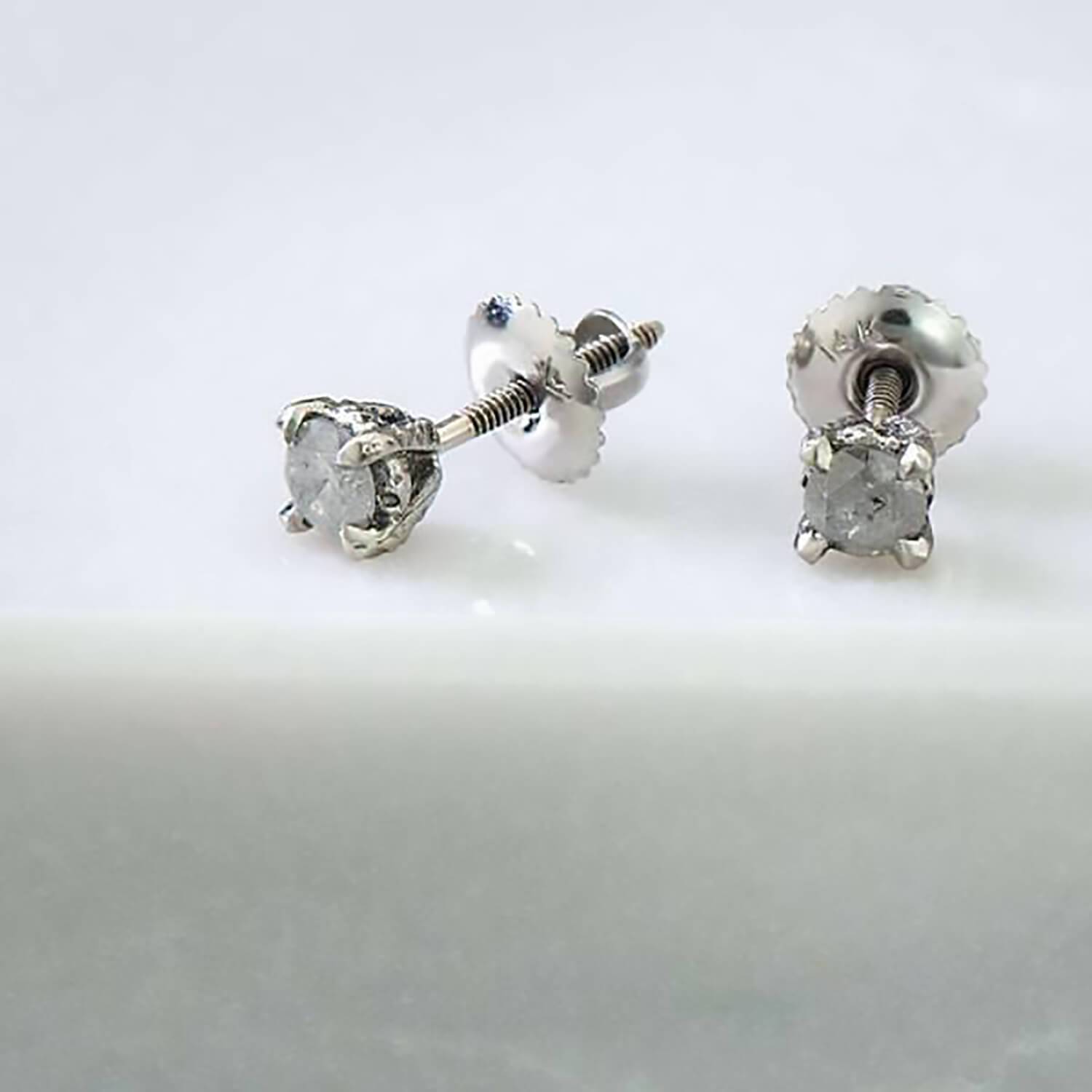 Recycled 14 karat white gold studs with a carved baroque texture and two 4mm natural round salt & pepper diamonds with a screw back system.