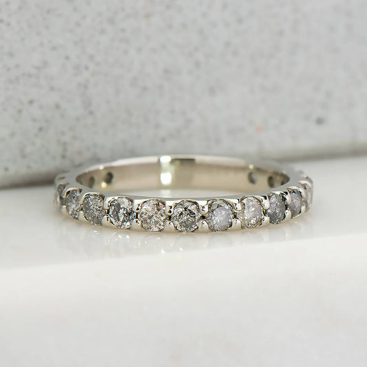Recycled 14 karat white gold eternity wedding band with 19 natural round salt & pepper diamonds
