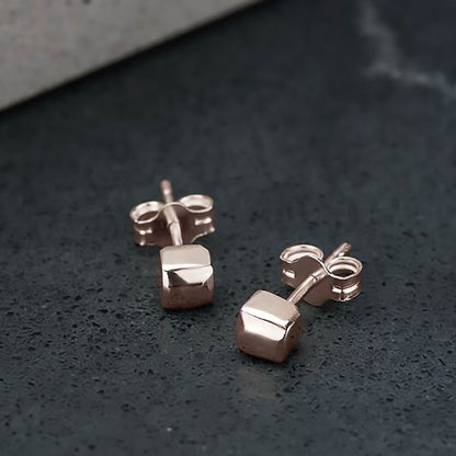 Recycled 10 karat rose gold tetragonal studs, they are cubic shaped and brought to a mirror polished finish.