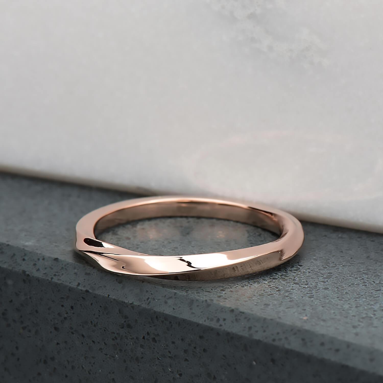 Recycled 10 karat rose gold with a half twist, the ring is 2mm in its width & thickness. It has been finished with a high mirror polish.