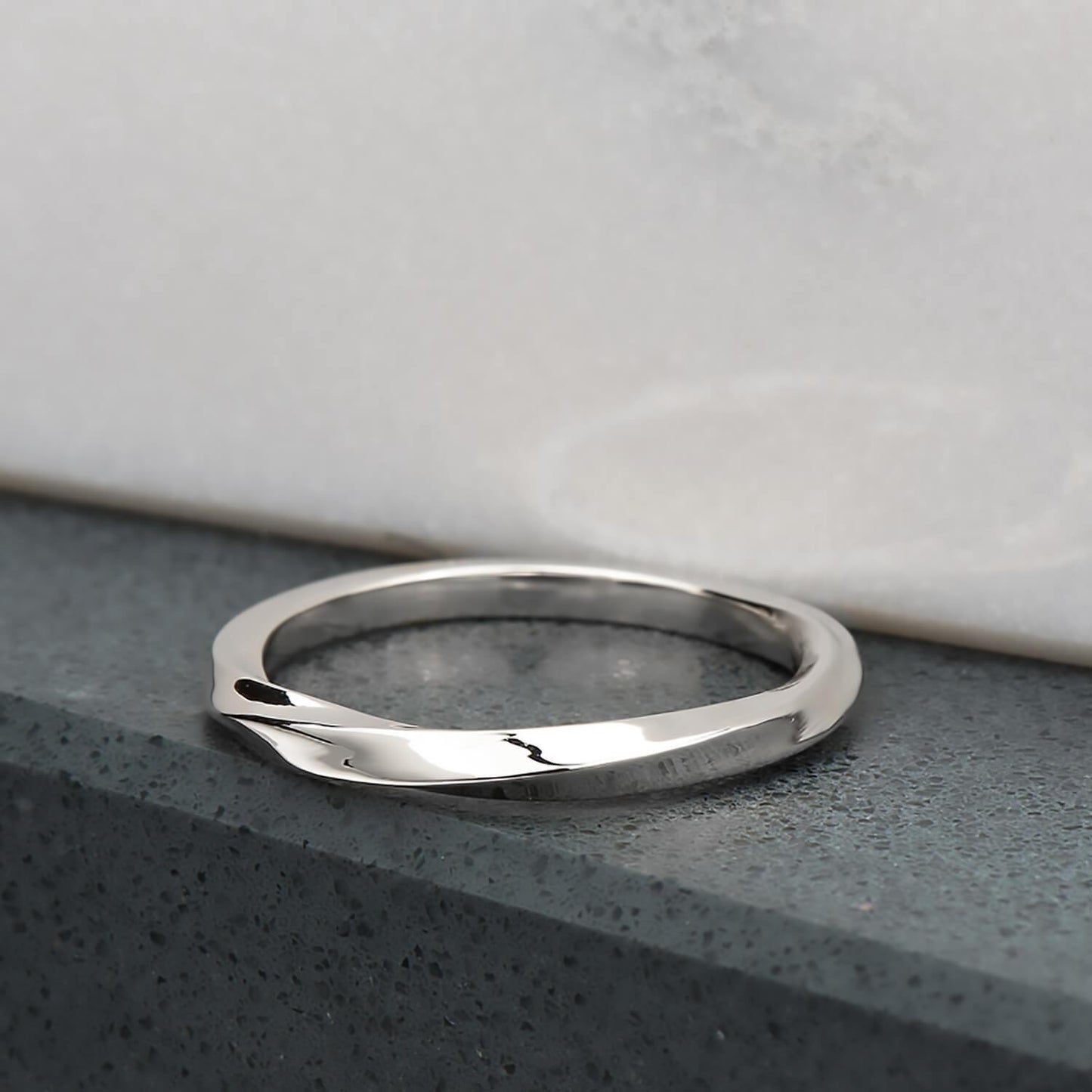 Recycled sterling silver with a half twist, the ring is 2mm in its width & thickness. It has been finished with a high mirror polish.