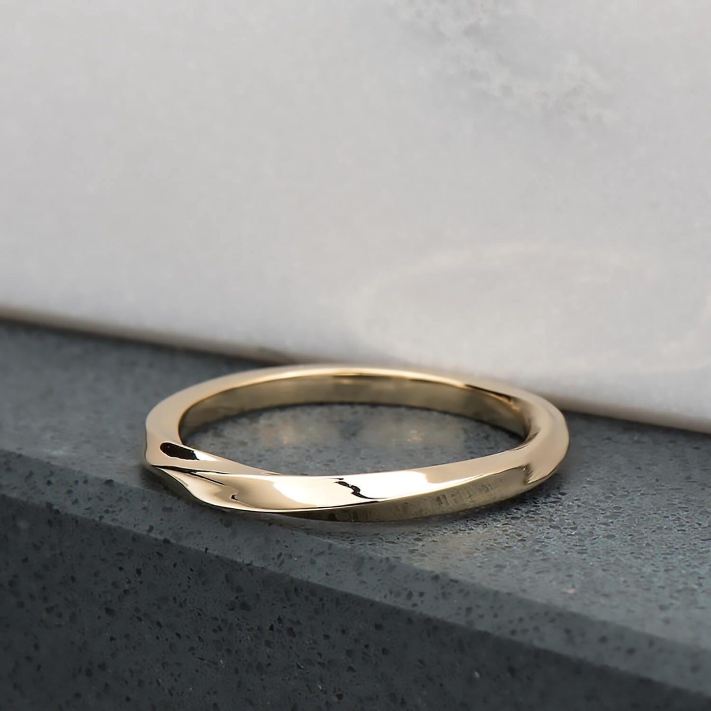 Recycled 10 karat yellow gold with a half twist, the ring is 2mm in its width & thickness. It has been finished with a high mirror polish.